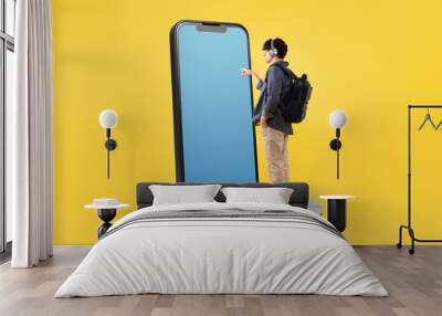 Student Guy Touching Smartphone Blank Screen On Yellow Studio Background Wall mural