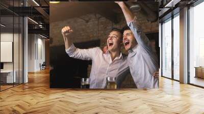 Successful businessmen drinking beer and shouting at the bar Wall mural