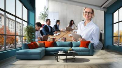 Successful Businesswoman Holding Digital Tablet Standing In Modern Office Wall mural