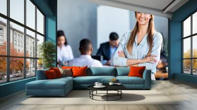 Successful Businesswoman Posing Standing In Modern Office During Meeting Wall mural