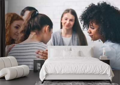 Support group patients comforting woman at therapy session Wall mural