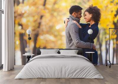 Sweet black couple hugging in autumn park Wall mural