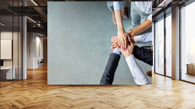 Teambuilding And Togetherness. Unrecognizable Business People Holding Hands Standing In Modern Office. Panorama, Above View, Empty Space Wall mural