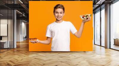 Teenager holding fresh salad and chocolate donut Wall mural