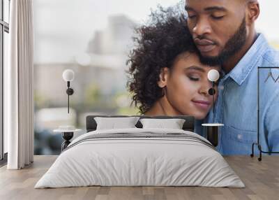 Tender black couple hugging with closed eyes Wall mural