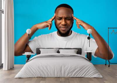 Thoughtful African Guy Thinking With Eyes Closed Over Blue Background Wall mural