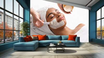 Top view of beauty therapist applying face mask Wall mural