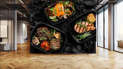 Top view of coal cooked healthy food in take away boxes Wall mural