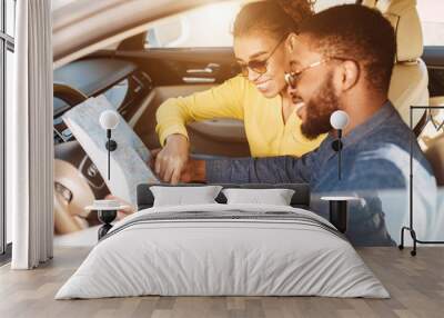 Travel Concept. Afro Couple Using Map In Car Wall mural