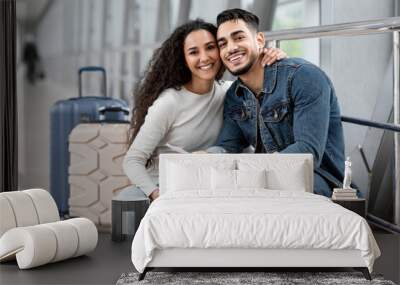 Travelling Together. Portrait Of Happy Middle Eastern Spouses Posing At Airport Wall mural