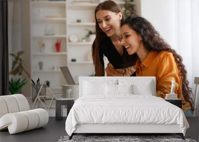 Two Happy Ladies Using Laptop Computer Working Online In Office Wall mural