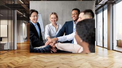 United Business Team Holding Hands Standing In Circle In Office Wall mural