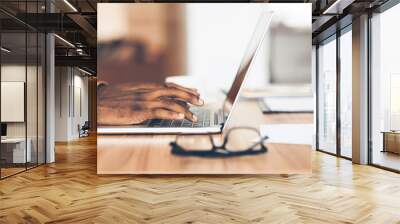 Unrecognizable black guy working on his laptop Wall mural