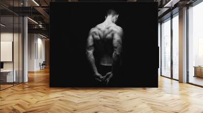 Unrecognizable man shows strong back muscles closeup Wall mural