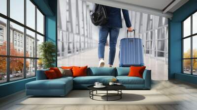 Unrecognizable Man With Bag And Suitcase Walking In Airport, Rear View Wall mural