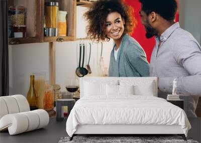 Vegetarian african-american couple cooking salad in kitchen Wall mural