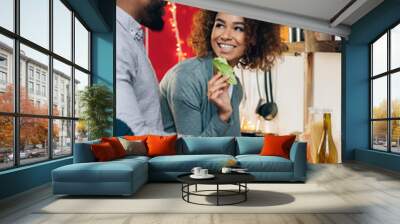 Vegetarian african-american couple cooking salad in kitchen Wall mural