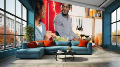 Vegetarian african-american couple cooking salad in kitchen Wall mural