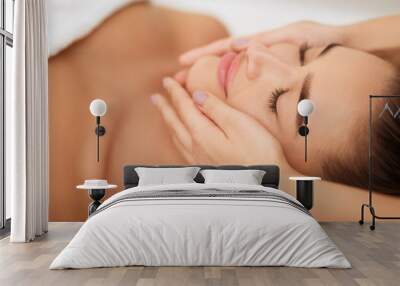 Woman getting face massage at beauty salon, closeup Wall mural