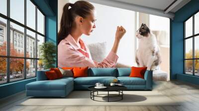 Woman Having Problem With Cat Discipline Showing Fist Indoor Wall mural