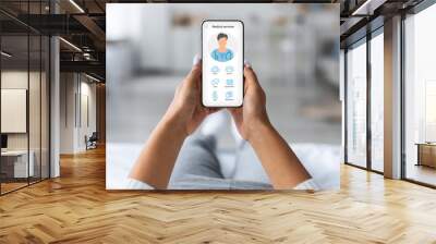 Woman laying on bed with mobile phone, using medical app Wall mural