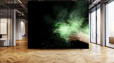 Yellow explosion of holi color powder inside clapping hands Wall mural