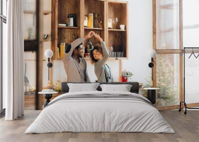 Young african-american couple dancing in kitchen, copy space Wall mural