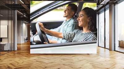 Young brunette lady driving car, having car trip with husband Wall mural