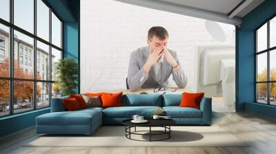 Young businessman in office with computer Wall mural