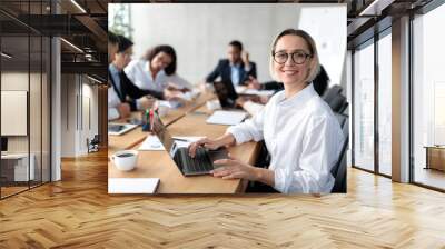 Young Businesswoman Sitting At Laptop Having Corporate Meeting In Office Wall mural