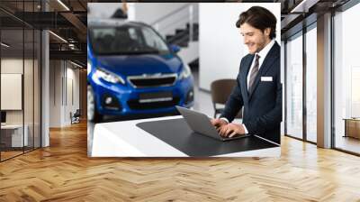 Young Car Seller Standing In Luxury Dealership Office Wall mural