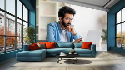 Young Indian Male Writer Working With Laptop At Home Office Wall mural