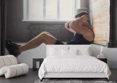 Young man fitness workout, sit-up crunches for abs Wall mural