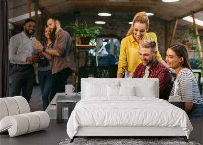 Young web designers working together at modern office Wall mural