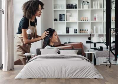 Young woman looking for changes, trying new hairstyle at beauty salon Wall mural