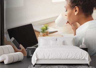 Young woman using laptop with blank screen Wall mural