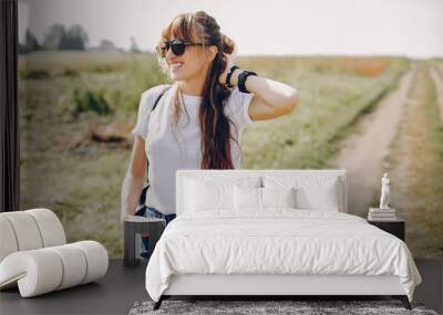 Beautiful girl in a park. Stylish girl in a white t-shirt Wall mural