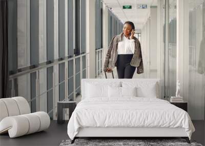 Black woman with suitcase at the airport Wall mural