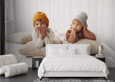 Children in a studio. Little girl with her brother. Boy in a white sweater. Wall mural