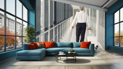 Elegant old man at the airport with a suitcase Wall mural