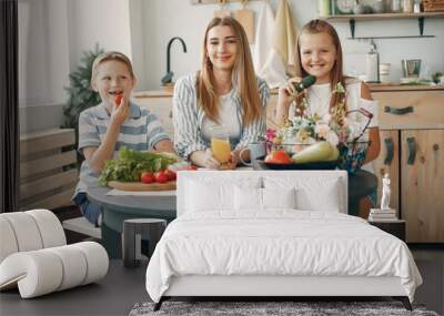 F in a kitchen. Blonde in a white t-shirt. Woman with vegetables Wall mural