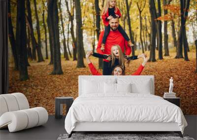 Family with cute kids in a autumn park Wall mural