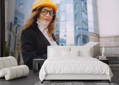 Female architect with construction site on the background Wall mural