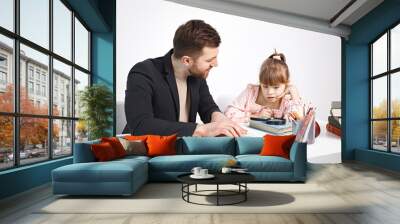 Girl with Down syndrome studying with her teacher at home Wall mural