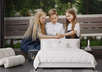 Happy children sitting together close and smile Wall mural