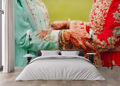 hindu bride walks behind husband holding garb Wall mural