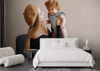 Mother with cute daughter. Blonde with long hair. Little child in a stylish clothes Wall mural