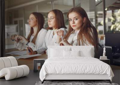 Students in a park. Girls lying on a grass. Friends with a notebooks. Wall mural