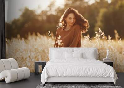 Stylish woman spending time in a summer field Wall mural