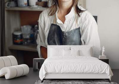 Woman in a pottery. Master make a dishes. Artist works with a clay Wall mural